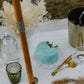 Teal cake with a 'I love you' message on a luxurious picnic table setting